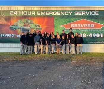 A group of SERVPRO Employees standing in front of a SERVPRO vehicle. 
