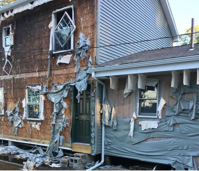 fire damaged home with siding burned off